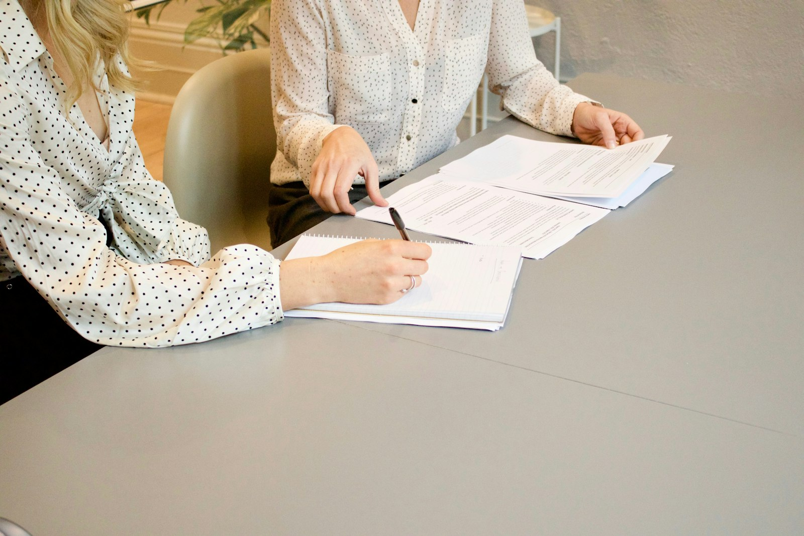 Client signing legal documents with an attorney